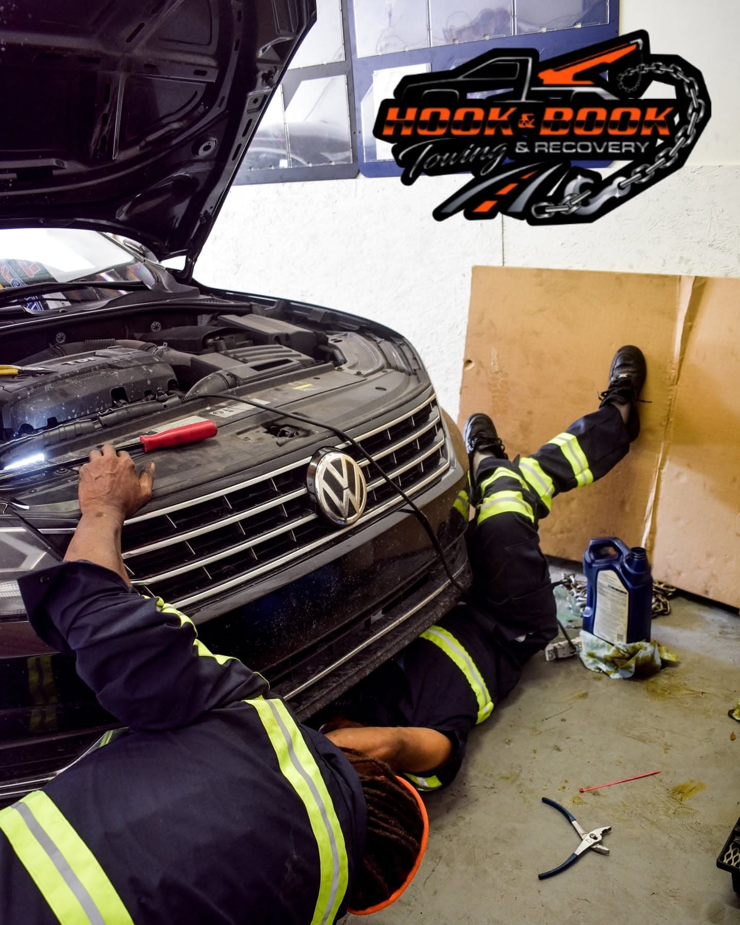 Hook & Book crew working on a Volkswagen in the shop